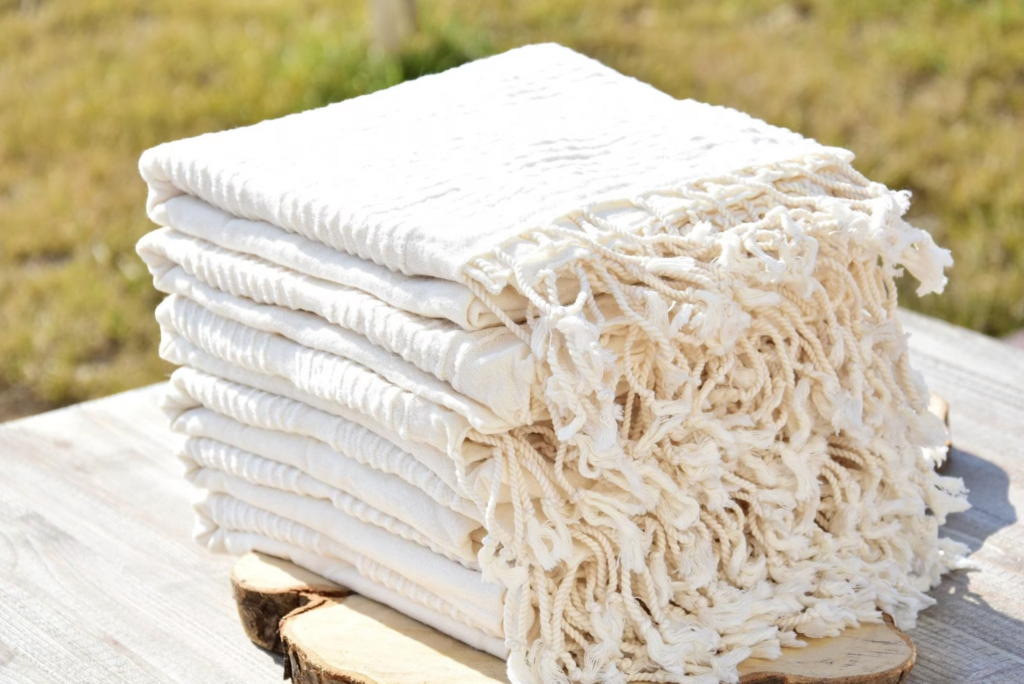 a stack of white bohemian style turkish peshtemals