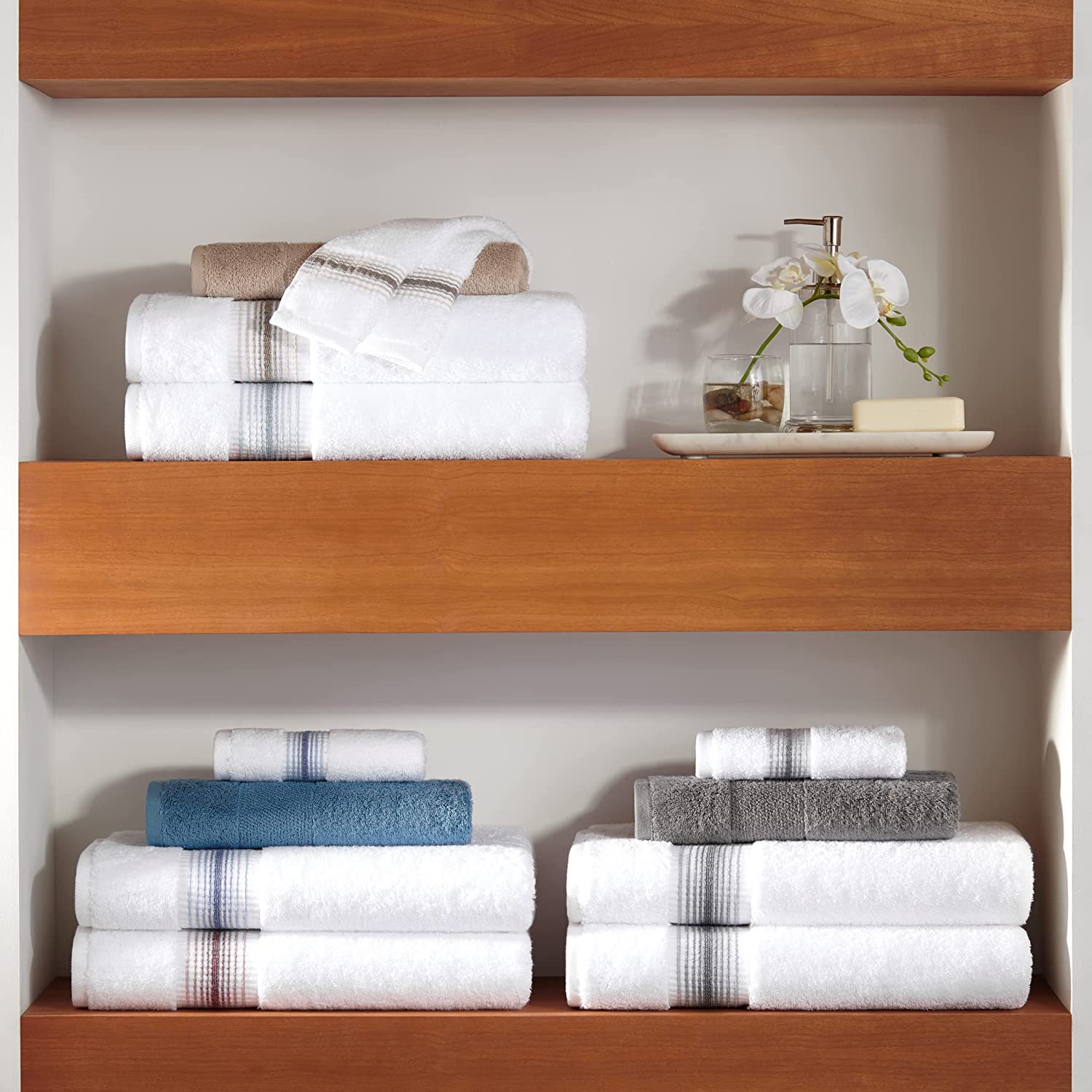 three turkish bath towels folded nicely on wooden shelves